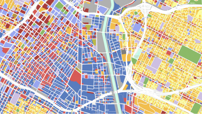 A stylized digital map of a city in dark colors with various routes and infrastructure glowing
