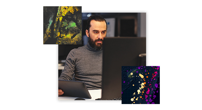 A person in an office using a desktop computer and a tablet overlaid with two colorful maps 