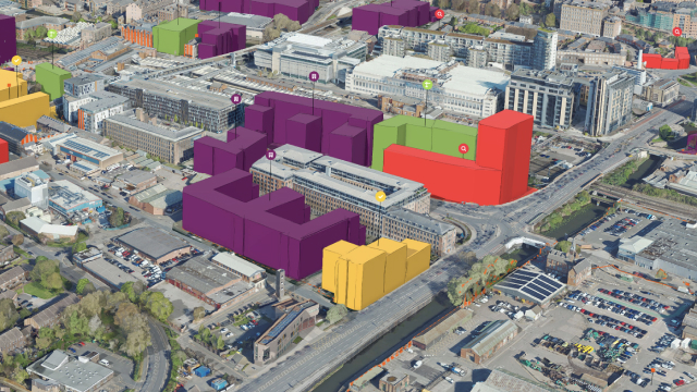 Perfil urbano en el que aparecen edificios altos, árboles verdes y un cielo azul con determinados edificios resaltados en rojo con una chincheta de mapa encima