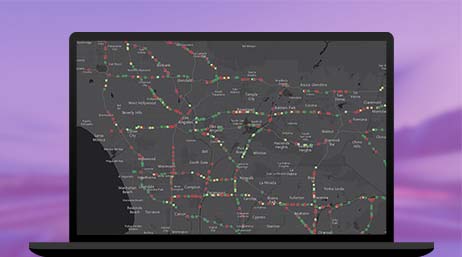 Un gráfico de un monitor de ordenador portátil que muestra puntos multicolor en un mapa de ruta negro y gris sobre un fondo violeta