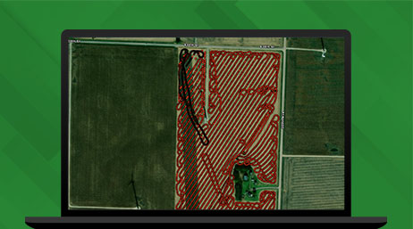 Graphic of a laptop monitor displaying a pattern map of a green field with a red grid, over a green background