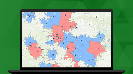 Un portátil que muestra un mapa con secciones resaltadas en rojo y azul y ubicaciones punteadas que ilustran una entidad en ArcGIS Business Analyst