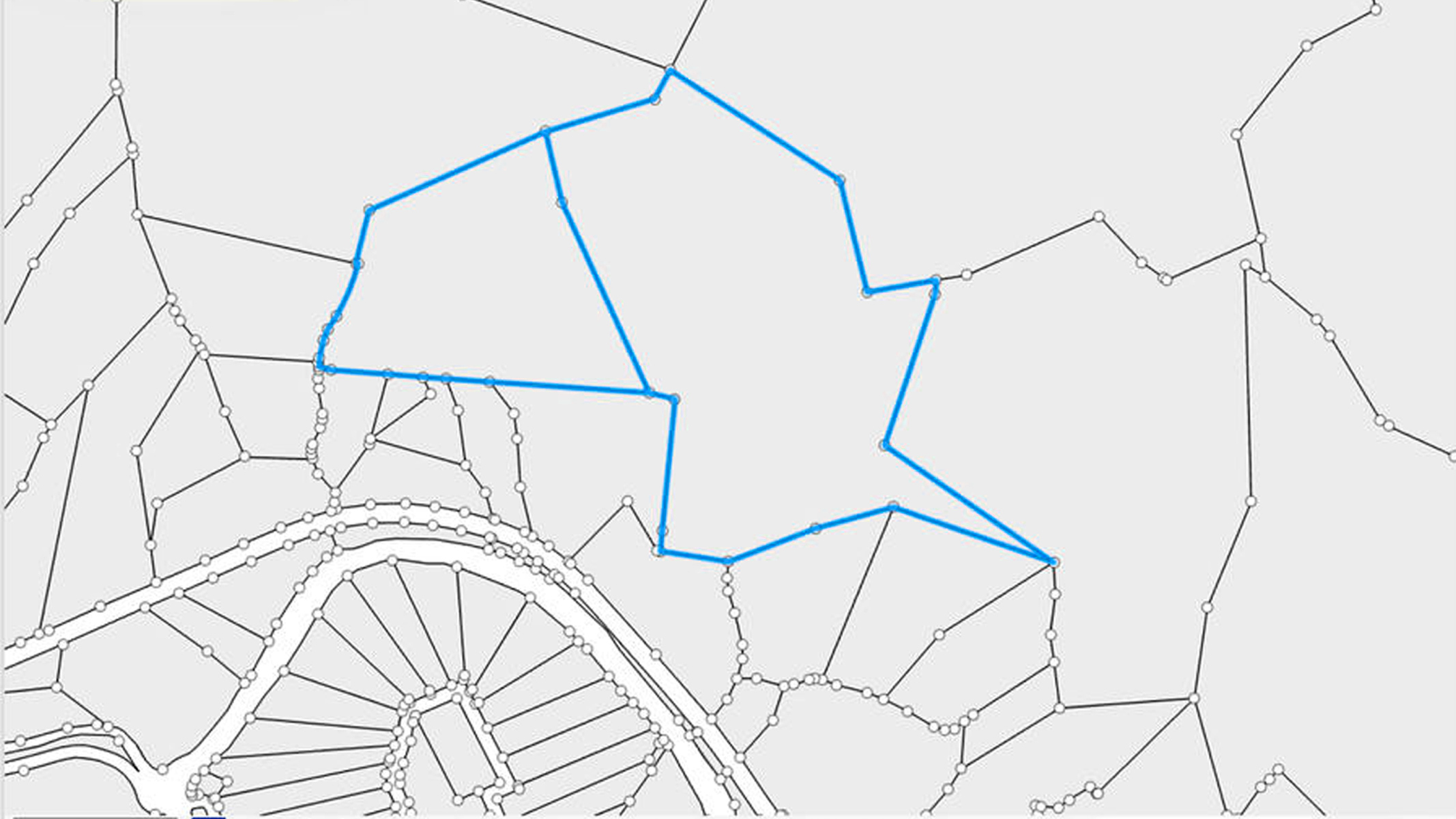 Un mapa con una red de líneas y nodos, con un gran polígono irregular resaltado en azul.
